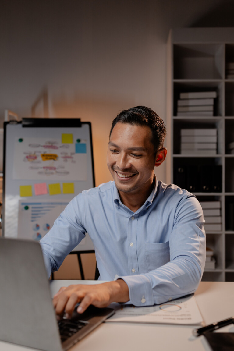 asian businessman sits in the office of startup company. he is a