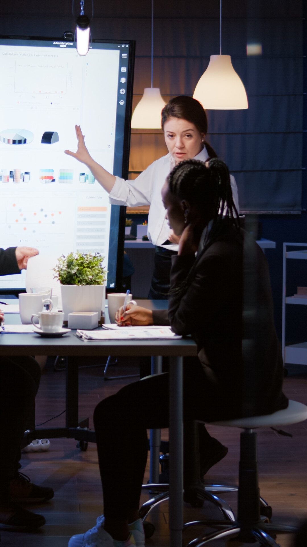 diverse multi ethnic businesspeople analyzing management strategy working overtime