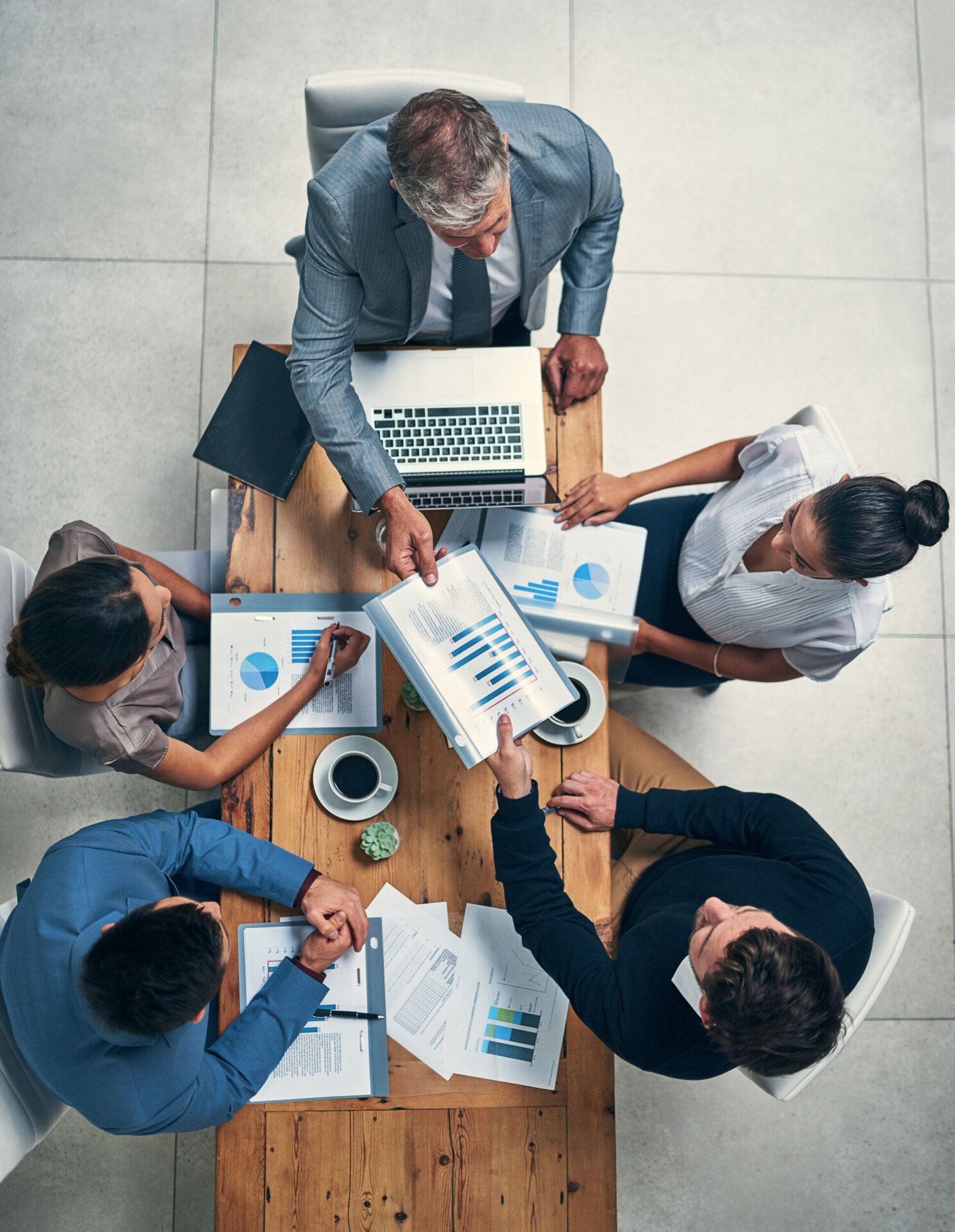high angle shot of a group of businesspeople having a meeting in an office.
